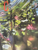 Content Magazine cover featuring a vibrant painted garden scene with lush foliage pink flowers and warm light artistic Magazines cover artwork by Roan Victor