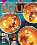 Soups magazine cover featuring bowls of creamy orange soup topped with crunchy croutons herbs and cream alongside text about 121 hot and hearty recipes
