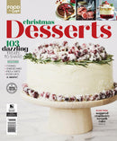 Christmas Desserts magazine cover featuring a white frosted cake decorated with sugared cranberries and rosemary on a wooden cake stand