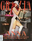 Grazia Italy Magazine cover featuring a red haired woman in a white outfit and cap posing in a stylish bar with Italian cover headlines and fashion stories