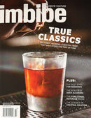 Imbibe Magazine cover featuring an amber cocktail in a glass with ice and splashes alongside True Classics cocktail culture headlines
