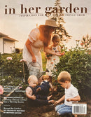 In Her Garden Magazine cover featuring a mother and children planting flowers in a garden with gardening inspiration and family growing stories
