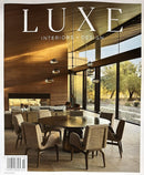 Luxe Interiors & Design New York Magazine cover featuring a sophisticated dining room with wood walls floor to ceiling windows and sculptural pendant lights