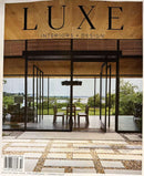Luxe Interiors & Design New York Magazine cover featuring a modern glass home with warm wood interiors, garden views, and a landscaped stone patio