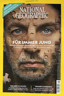 National Geographic Germany Magazine cover featuring a close up portrait of a bearded man with puzzle pieces across his face and German feature headlines about summer adventures