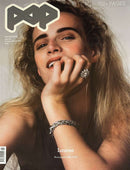 Pop Magazine cover featuring a close up portrait of a woman with long hair and her hand near her face wearing sparkling jewelry with a 700 plus pages label
