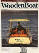 Wooden Boat Magazine cover featuring a classic wooden boat named Vega on the water with boating features and magazine headlines